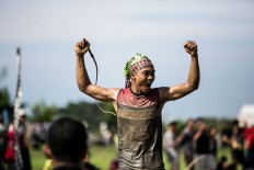 The winning jockey celebrates his victory after a buffalo race in Kaliakah village in Jembrana. JP/ Agung Parameswara