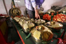 A buyer checks out the gamelan sets at the workshop. JP/Aditya Sagita