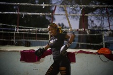 In this Jan. 24, 2017 photo, boxer Legnis Cala poses for a photo before a training session, at a sports center in Havana, Cuba. Women were first allowed to box at the Olympics during the 2012 Summer Olympics but they are still not allowed to box in Cuba. AP/Ramon Espinosa