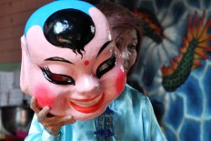 A woman wears the costume of a Chinese god following the Grebeg Sudiro festival in Pasar Gede, Surakarta, Central Java, on Jan. 22. JP/ Magnus Hendratmo