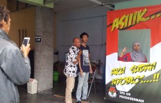 Polling station Pujokusuman TPS 09 in Yogyakarta is staffed only by women and provides a backdrop for selfies so voters can share them through their social media accounts to encourage others to exercise their right. JP/Bambang Muryanto