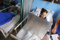 A patient at Tarakan Hospital, Central Jakarta, casts a vote from her bed. The General Elections Commission (KPU) has provided mobile polling stations to meet the needs of hospitalized voters. JP/Seto Wardhana