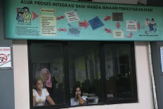 Two prisoners watch election activities from the window at the Pondok Bambu Women’s Penitentiary in East Jakarta. One hundred and fifty-seven prisoners cast their votes in the Jakarta gubernatorial election at the prison on Wednesday, Feb. 15, 2017. JP/Wendra Ajistyatama