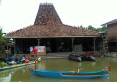 Eligible voters in Mintobasuki village, Gabus district, Pati regency, Central Java, have to use boats to reach the TPS 2 polling station due to widespread flooding in the area. JP/Suherdjoko