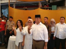 Jakarta gubernatorial candidate number 3 Anies Baswedan with his wife and daughter show their inked fingers after voting in South Jakarta on Wednesday, Feb. 15, 2017. JP/ Indra Budiari