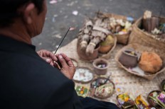 A Hindu priest prays over offerings for ancestors in a ceremony in Songan village on Monday, February 13, 2017. JP/Anggara Mahendra