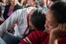 A woman grieves for a loved one who died in a landslide in Songan village on Monday, February 13, 2017. JP/ Anggara Mahendra