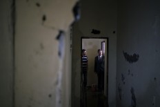 In this Feb. 2, 2017 photo, Claudio Lamachia, head of Brazil's Bar Association, right, stands in a cell where several inmates were killed at the Anisio Jobim penitentiary complex, known by its Portuguese acronym of Compaj, in Manaus, Brazil. "Our prisons are universities of crime and we are financing drug gangs inside the prisons by overcrowding them," he said. AP Photo/Felipe Dana
