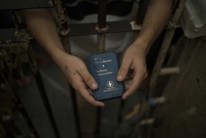 In this Feb. 6, 2017 photo, a detainee holds a Bible inside an overcrowded cell at a police station near Manaus, Brazil. A recent study by think-tank Fundacao Getulio Vargas estimates that 40 percent of Brazilian prisoners have not been convicted. AP Photo/Felipe Dana