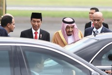 President Joko "Jokowi" Widodo escorts King Salman bin Abdulaziz Al Saud to his car after greeting him at Halim Perdanakusuma Airport.  JP/Dhoni Setiawan