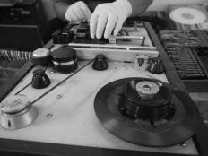 A staff member manually processes a cassette. JP/Ganug Nugroho Adi