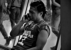 Aprilia Manganang of the Jakarta Elektrik PLN makes a phone call while crying after her team lost on March 18. JP/Aman Rochman