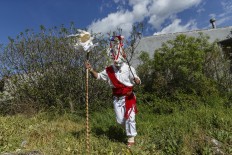 In this April 1, 2017 picture a reveler in a mask from the traditional La Vijanera de Silio carnival runs after picking a branch from a tree during a parade at a gathering of different villages' carnival masks and characters in the small village of Casavieja, Spain, Monday, April 3, 2017. These festivals, held across central and northwestern Spain, most often coincide with festivities celebrating the advent of spring, mixing Carnival and bizarre pagan-like rituals with mock battles between good and evil. AP/Daniel Ochoa de Olza