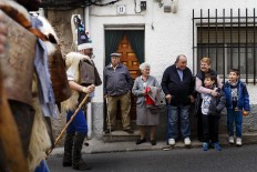In this April 1, 2017 picture a family looks as 'Zarramacos' ring their cowbells in a representation of the traditional carnival of La Vijanera de Silio during a gathering of different villages' carnival masks and characters, in Casavieja, Spain, Monday, April 3, 2017.  AP/Daniel Ochoa de Olza