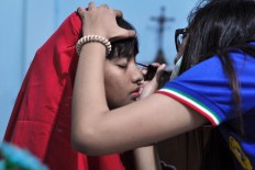 A young girl playing the role of Mary Magdalene applies stage make up for an Easter performance at at Yohanes Rasul church, Wonogiri, Central Java on Friday April 14. JP/Magnus Hendratmo