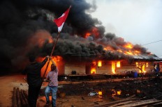 Engulfed by fire: Selamatkan merah putih (Save national flag) by Jessica Helena Wusyang