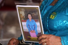 A participant holds a picture of herself that she bought from a photographer after her performance.  JP/Aditya Sagita