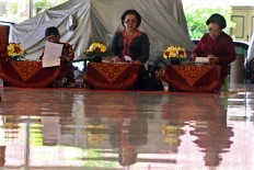 A panel of three judges listen and assess a performance. JP/Aditya Sagita