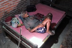 Mbah Jo Gotho lies on his bed while listening to his radio at his house in Sragen, Central Java, in this Sept. 8, 2016, file photo. Even though he was already 146 years old, he could still hear clearly. JP/Magnus Hendratmo