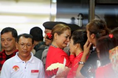 A Supporter of Basuki "Ahok" Tjahaja Purnama cries while others stand in shock upon hearing that the incumbent Jakarta Governor was sentenced to two years' imprisonment. JP/ Seto Wardhana