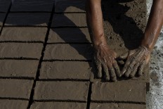 A woman makes bricks in Trowulan, Mojokerto, East Java. Women are responsible for fashioning the brick molds. JP/Sigit Pamungkas