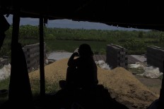 A brick maker sits and rests in a hut. JP/Sigit Pamungkas