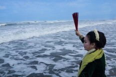 A woman prays at Parang Kusumo Beach, Yogyakarta, during the Labuhan ceremony on April 27, 2017. JP/Tarko Sudiarno