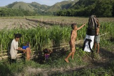 Getting ready: After crossing the river, the children need some time to get ready for school. JP/ Tarko Sudiarno