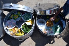 Various fruits and other food inside tenong (containers made of aluminum or bamboo). JP/Stefanus Ajie