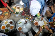 Villagers share their food after the Nyadran ritual at the Puroloyo Cemetery, Tunggulsari, Cepogo, Boyolali regency, Central Java, on May 14. JP/Ganug Nugroho Adi