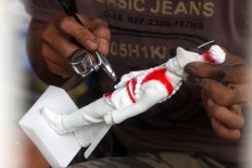 A man paints a Yogyakarta Sultanate royal soldier sculpture after molding it at Patuk, Gunungkidul, Yogyakarta, on Feb. 21. JP/Aditya Sagita