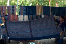 Sikka women show sacred traditional ikat cloths displayed during the exhibition. JP/Intan Tanjung