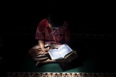 A student recites the Quran at the Lirboyo mosque. It is a routine activity for students at the boarding school. JP/Sigit Pamungkas