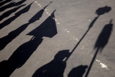 Shadows of artists are visible during the opening of the 39th Bali Art Festival at the Bajra Sandhi Monument in Denpasar. JP/Agung Parameswara