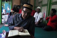 A transgender student recites and discusses a religious theme with his colleague. JP/Magnus Hendratmo