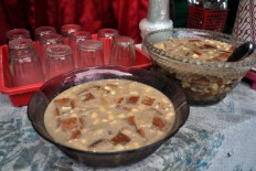 Kolak roti (bread dipped in coconut milk cooked with palm sugar) is made by Nur Ayu, 49. She took a cooking class after graduating from high school and she has a catering business now. JP/Magnus Hendratmo