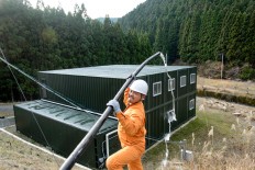  Rustono works to channel clean waters from the mountain for his new factory needs. JP/Tarko Sudiarno