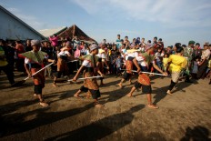 A group of dancers perform as part of the Lomban Festival on Kartini Beach, Jepara, Central Java, on July 2. JP/Maksum Nur Fauzan
