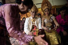 Kadek and Novi follow the ritual of a Balinese traditional wedding at Banjar Taman Yangbatu village in Denpasar on Feb. 2. JP/Anggara Mahendra