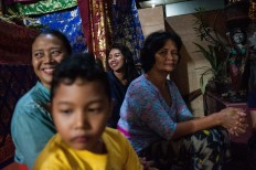 Relatives smile as Novi performs during the Megesah ceremony. JP/Anggara Mahendra