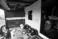 A worker prays in a temporary resting room. JP/Sigit Pamungkas