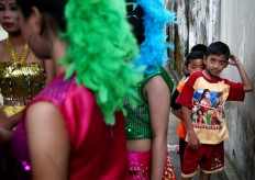 Some boys watch female dancers gear up for their turn to perform. JP/Aman Rochman