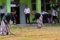 Students compete in the wheel race during the student orientation program. JP/Aditya Sagita