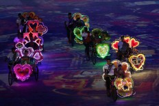 Dancers ride tricycles during their performance at the opening ceremony. JP/Seto Wardhana