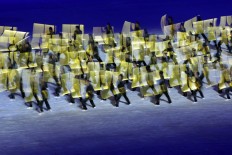 Dancers carry yellow boards during their performance at the opening ceremony. JP/Seto Wardhana