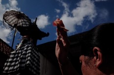 A Balinese Hindu performs prayers during the Tumpek Pengatag ceremony to worship Sanghyang Sangkara, or the god of plants. The ceremony takes place 25 days before Galungan day. JP/Anggara Mahendra
