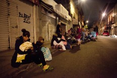 People gather on a street in downtown Mexico City during an earthquake on September 7, 2017.
An earthquake of magnitude 8.0 struck southern Mexico late Thursday and was felt as far away as Mexico City, the US Geological Survey said, issuing a tsunami warning. It hit offshore 120 kilometers (75 miles) southwest of the town of Tres Picos in the state of Chiapas.  AFP/ Ronaldo Schemidt