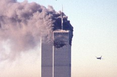 A hijacked commercial plane approaches the World Trade Center shortly before crashing into the landmark skyscraper 11 September 2001 in New York.  AFP/ Seth Mcallister