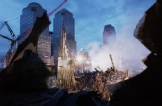 Early morning light illuminates the wreckage of the World Trade Center 25 September, 2001 in New York. Search and rescue efforts continue in the aftermath of the 11 September terrorist attack.  AFP/Eric Feferberg