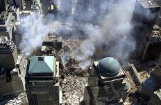 This photo released 17 September 2001 by the New York City Office of Emergency Management shows smoke rising from the ruins of the World Trade Center in lower Manhattan, New York 16 September 2001.   AFP/ NYC office emergency management/ HO